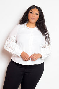 Plus-size model wearing white blouse with punched sleeves, stylish and comfortable, available in 1XL to 3XL.