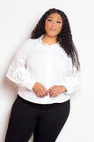 Plus-size model wearing white blouse with punched sleeves, stylish and comfortable, available in 1XL to 3XL.