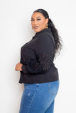 Plus-size model wearing a black blouse with punched sleeves, crafted from polyester and spandex, designed for sizes 1XL to 3XL.